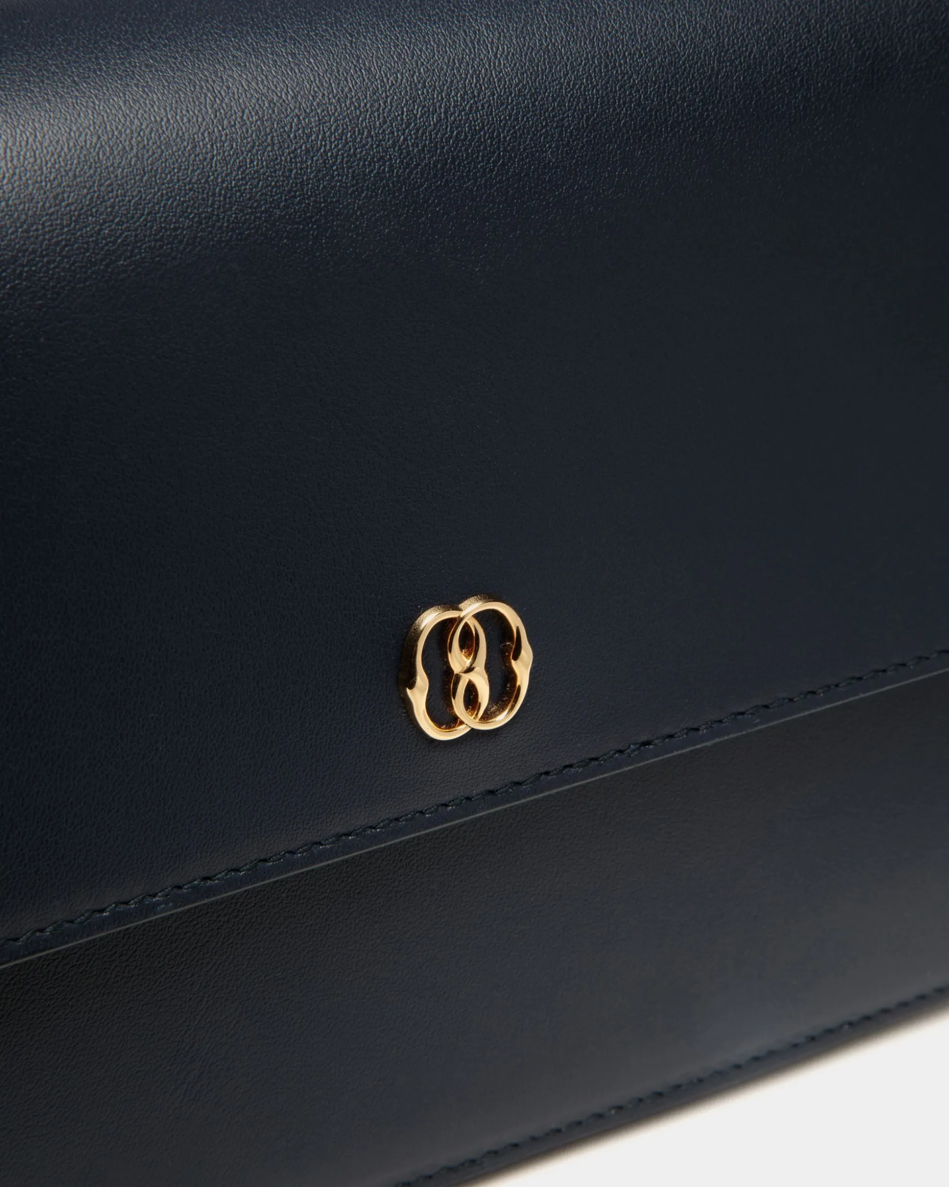 Emblem Small Crossbody Bag in Navy Blue Leather